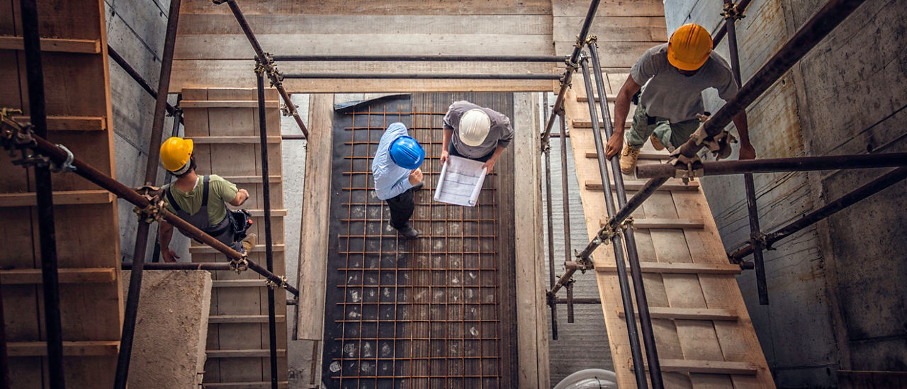 Construction workers on scaffolding at a construction site