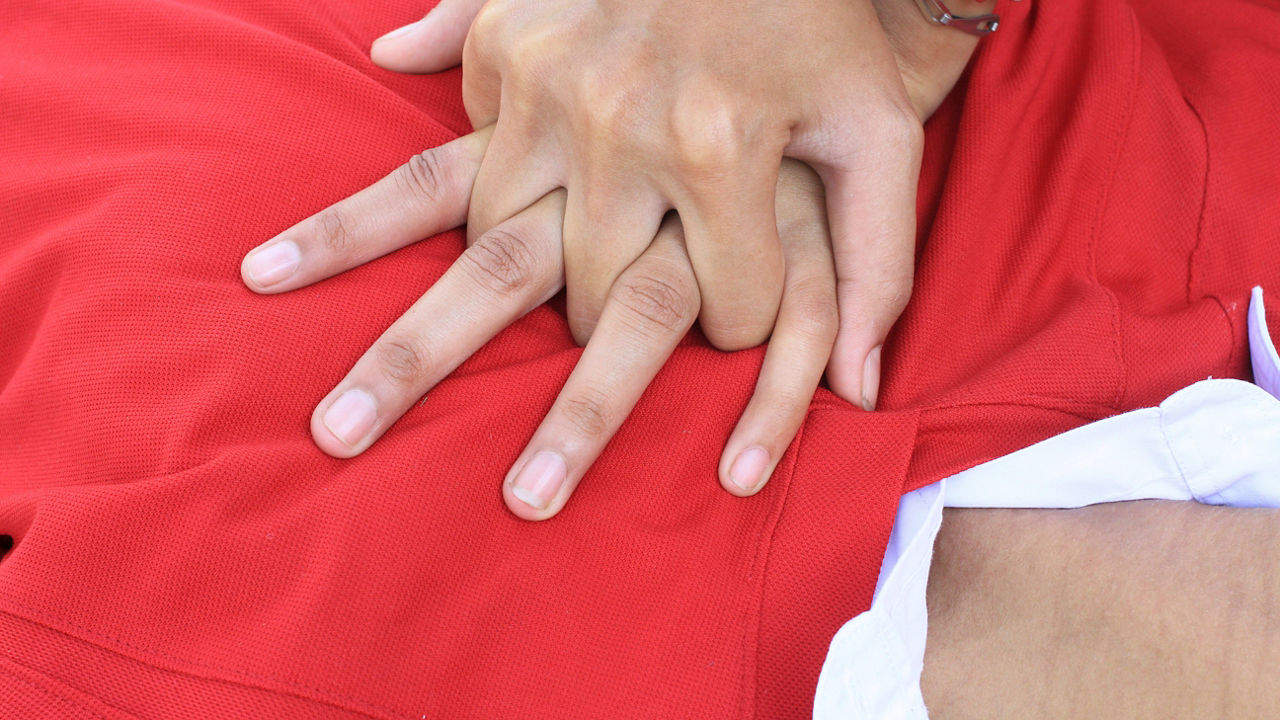 A person's hand is being placed on a person's back.