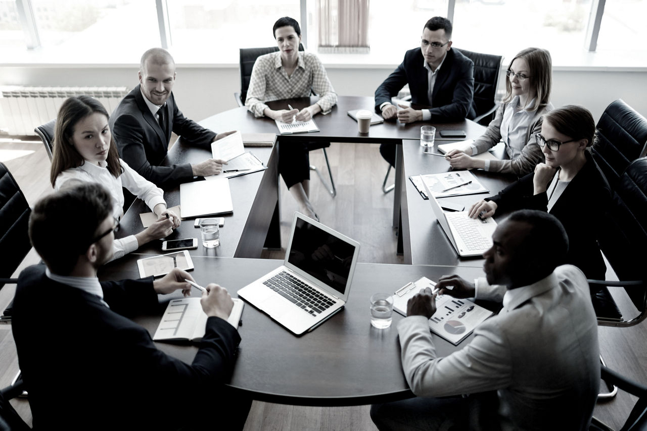 Executives sitting around a large table in a meeting