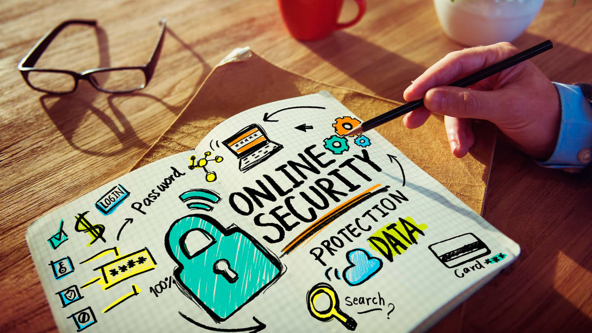 A hand holding a pencil over a piece of paper.