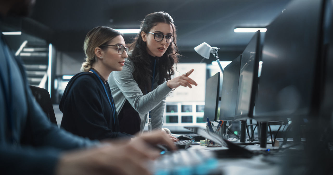 Women Working in a Cyber Security Software Development Department. Young Manager Updating Software Developer on the Artificial Intelligence Safety Project