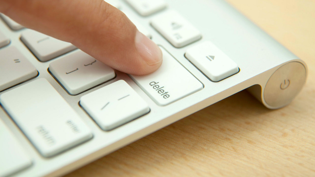 A person is pressing a button on a computer keyboard.