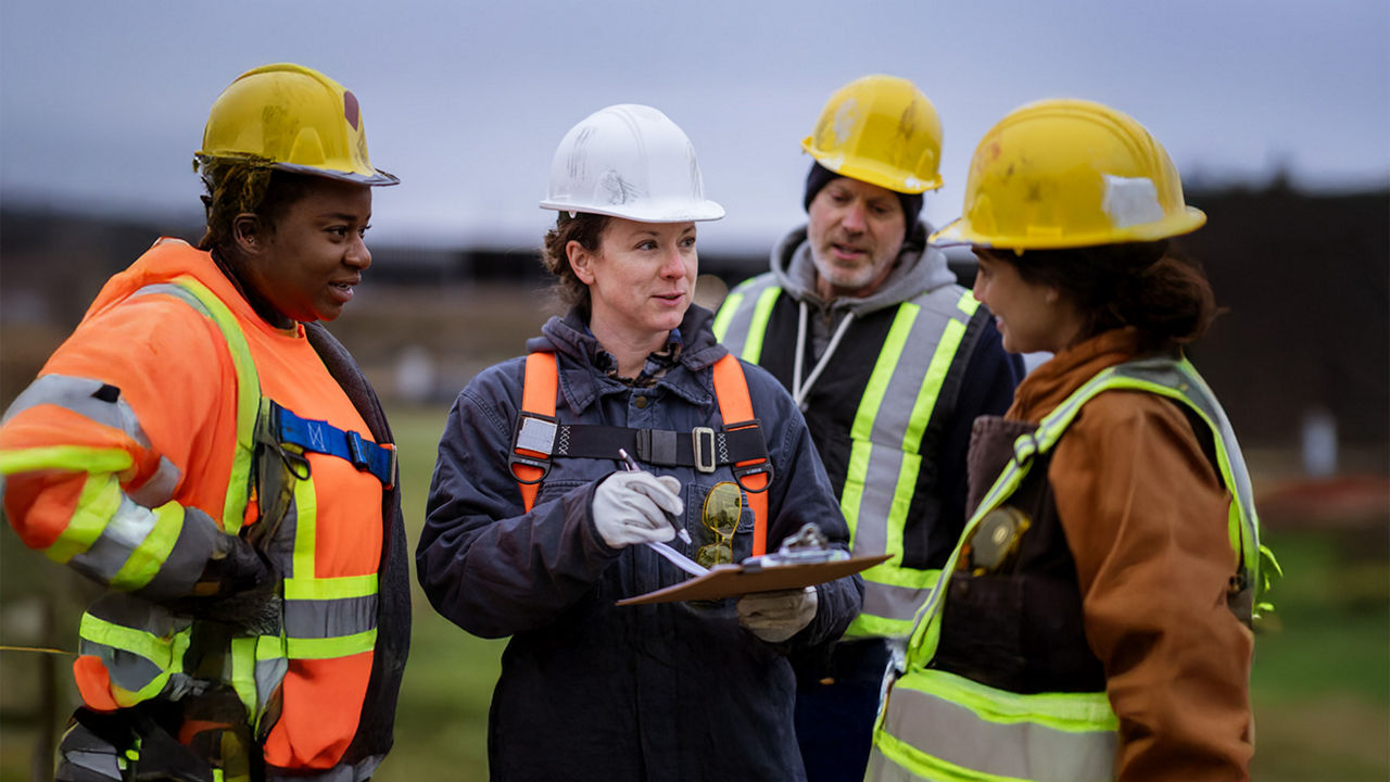 Utility workers wearing hard hats.