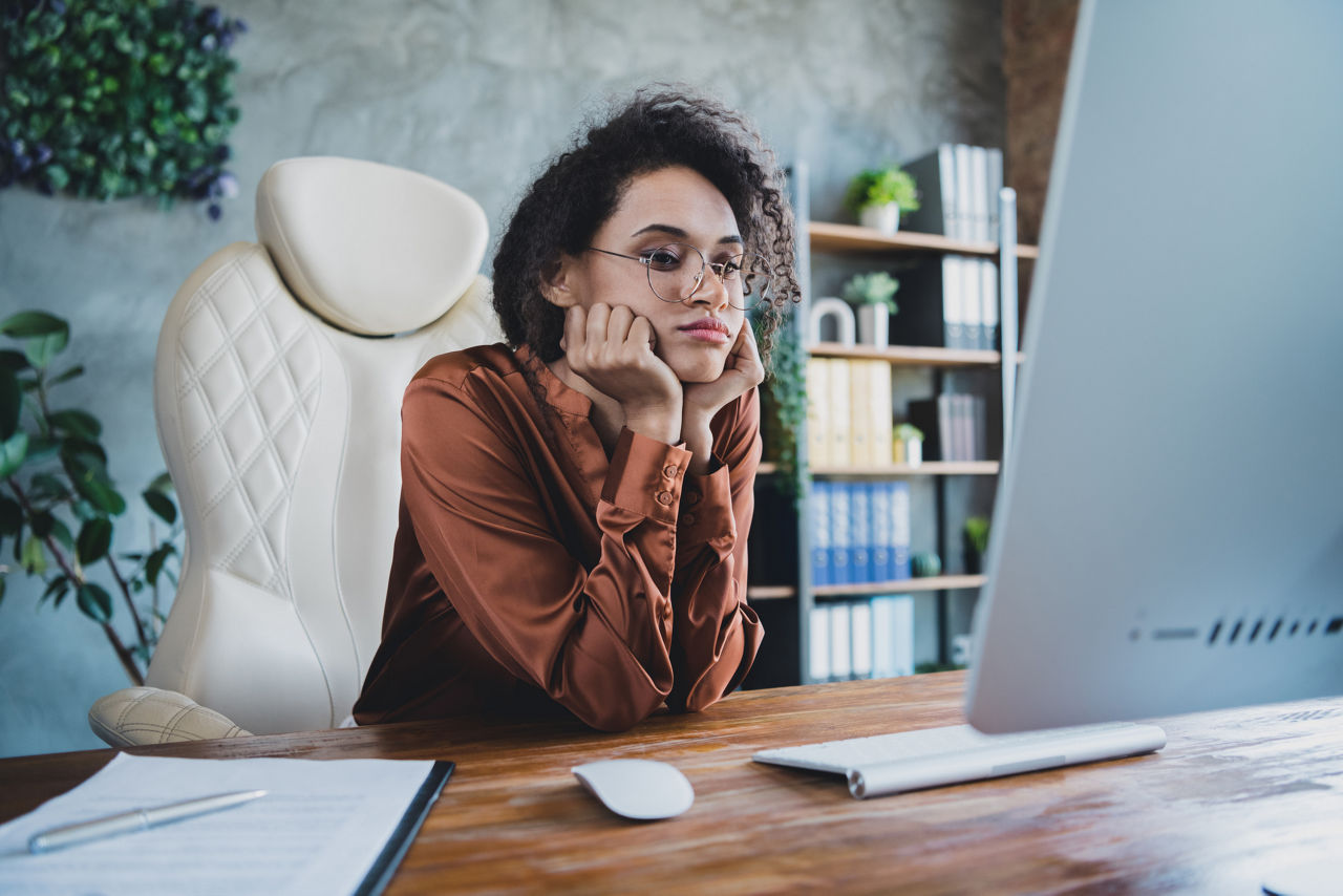 Portrait of tired unsatisfied economist girl sit chair hands touch cheeks watch boring webinar seminar business center inside.