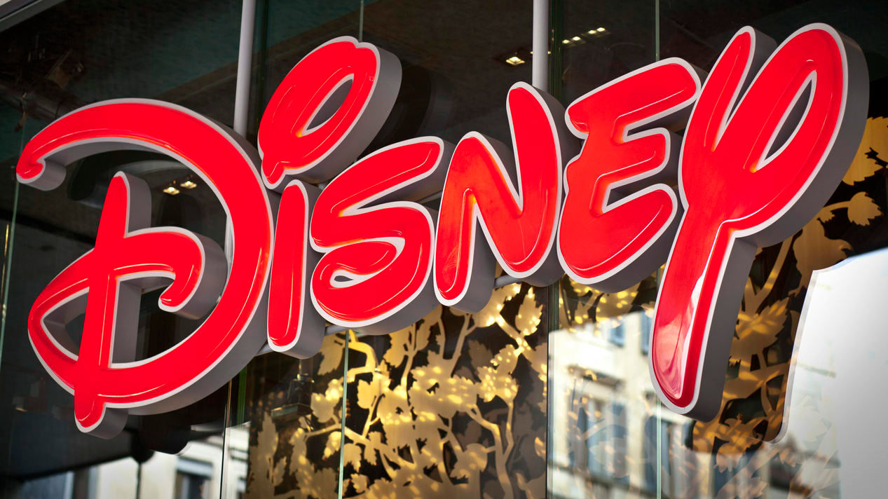 The disney logo is displayed on a store window.
