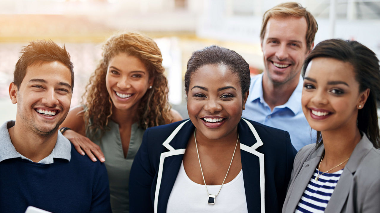 A group of business people smiling together.