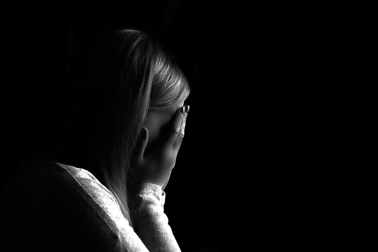 Portrait of a woman hiding her face with hands