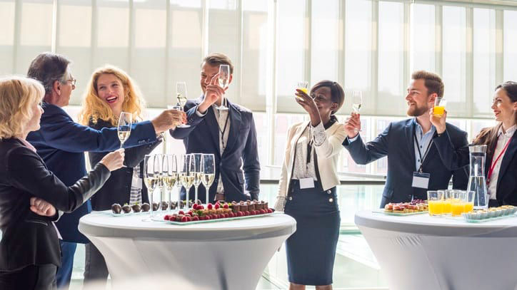 A group of business people toasting at an event.