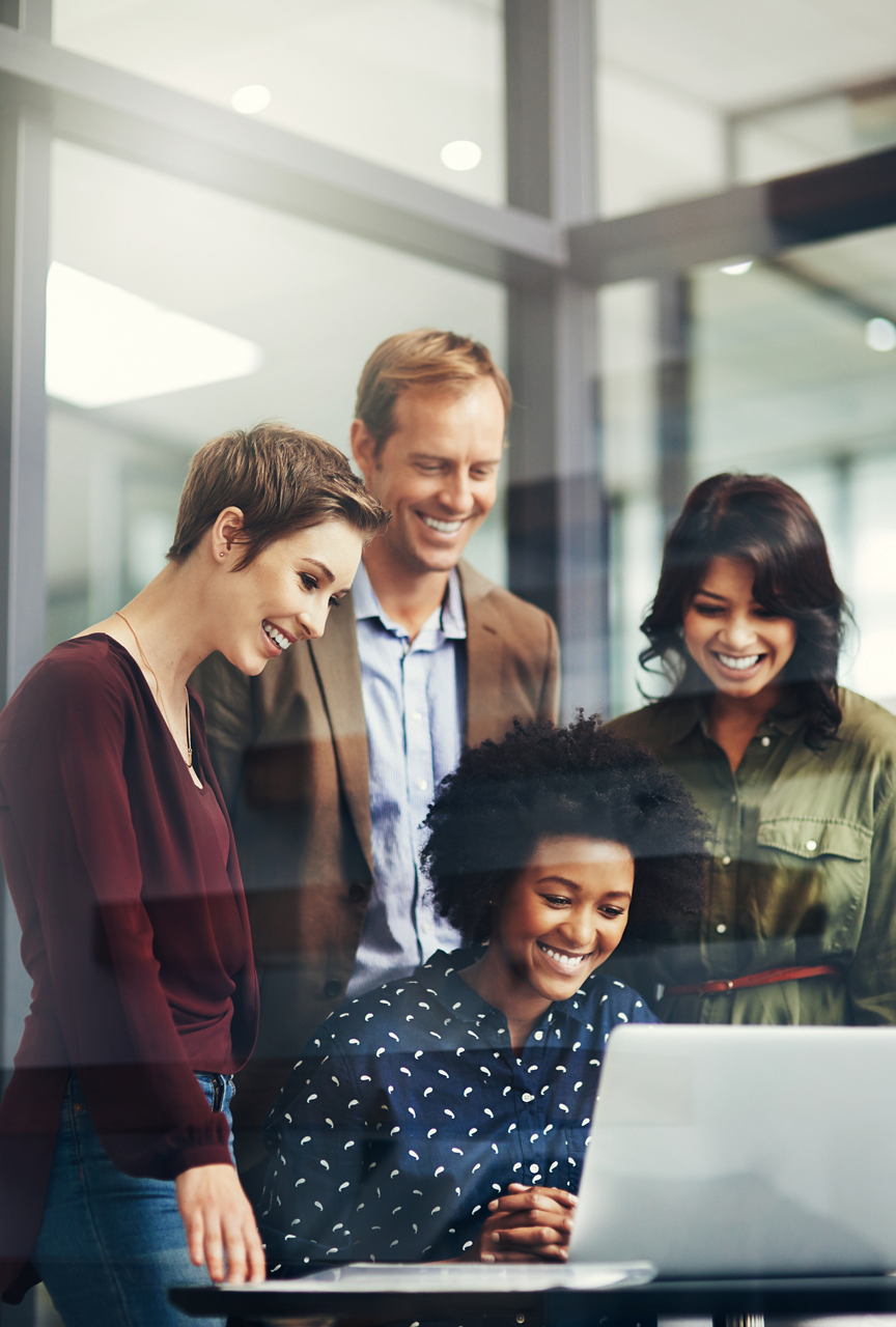 Shot of a group of colleagues using a laptop together at work