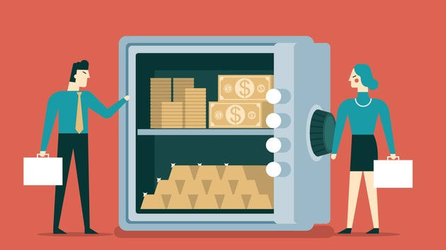 A man and woman standing next to a safe box with money in it.