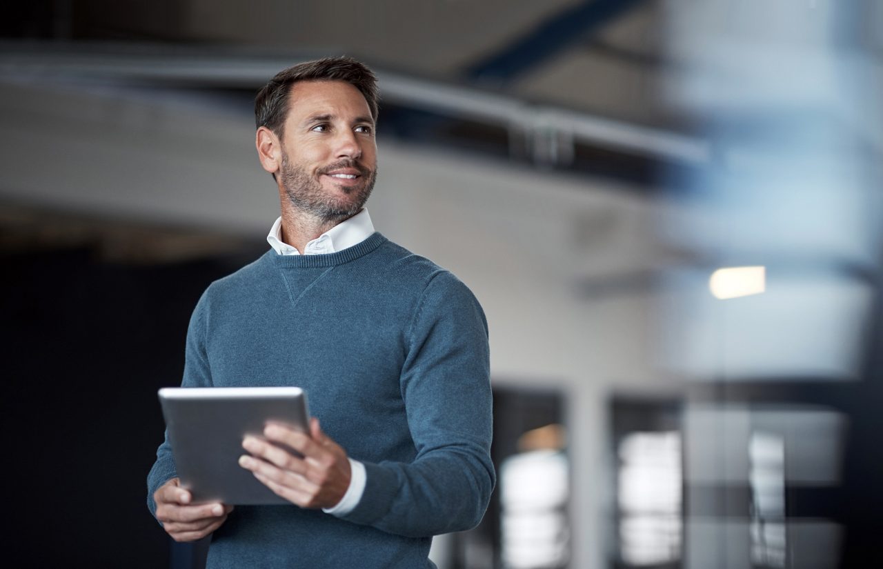 Cropped shot of a mature businessman working on his tablet in the office