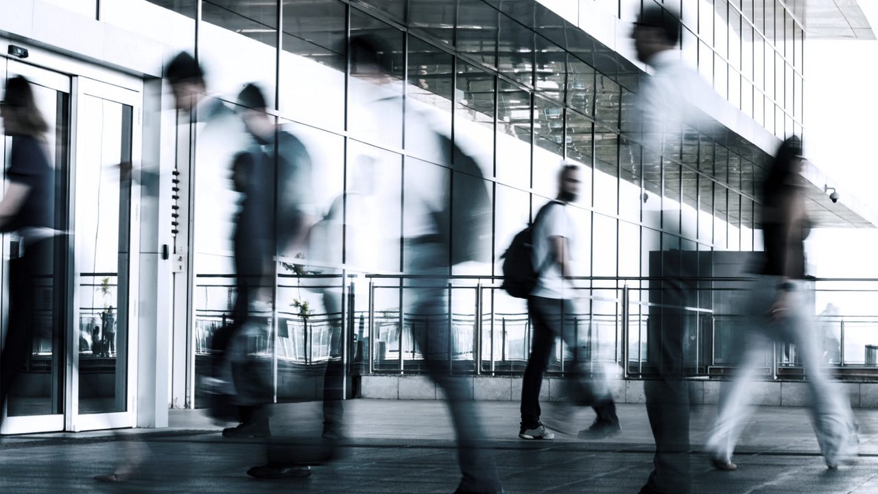 people walking in and out of an office