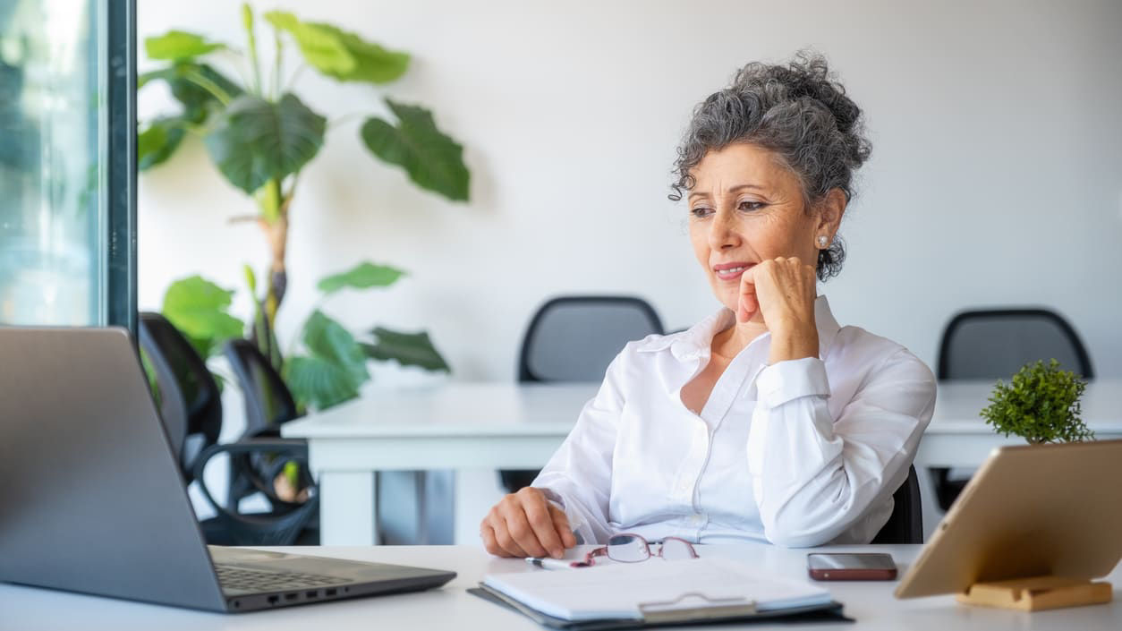 Senior businesswoman looking at her laptop in the office.