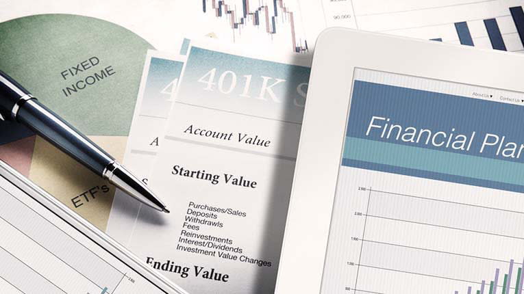 A tablet with a financial plan on it.