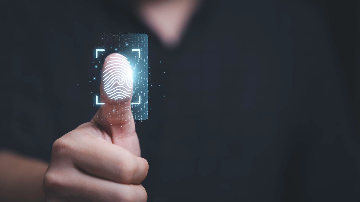 A man is pointing at a fingerprint on a credit card.