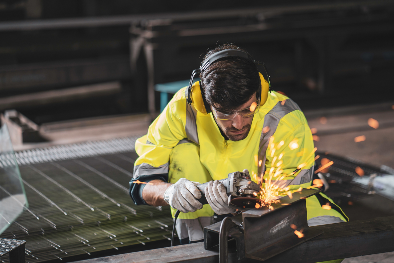 Man welding uniform headphones