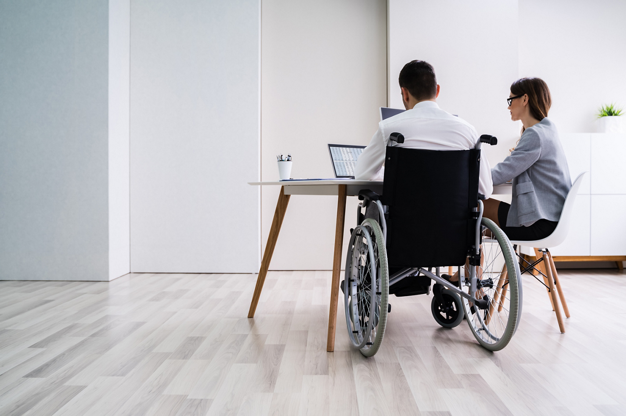 Man wheelchair woman sitting working
