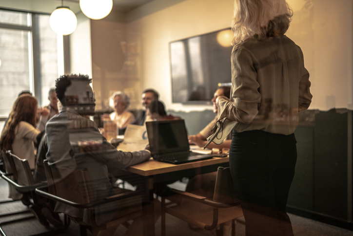 Businesswoman talking to his colleagues on presentation in the office