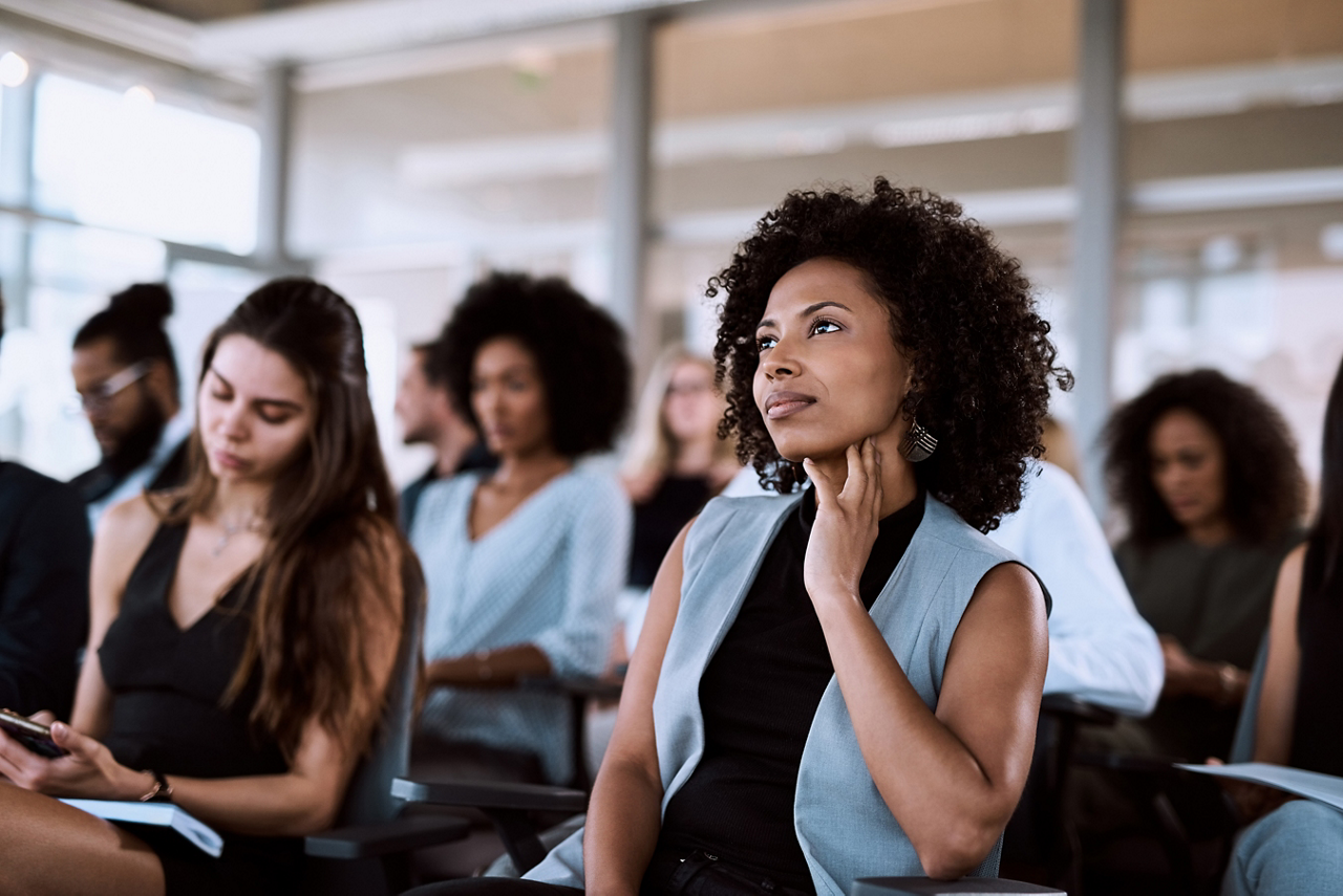 Shot of a businesswoman listening intently during a conference