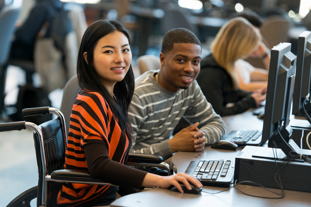 Diverse group of students using computers.