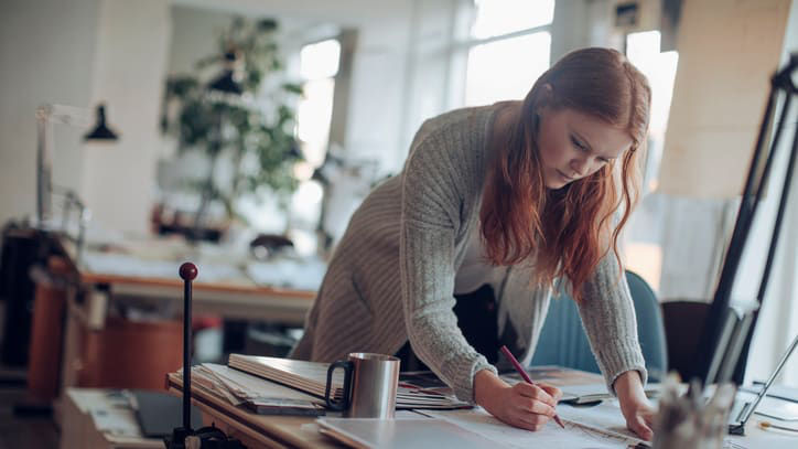 A woman working at a desk in an office.
