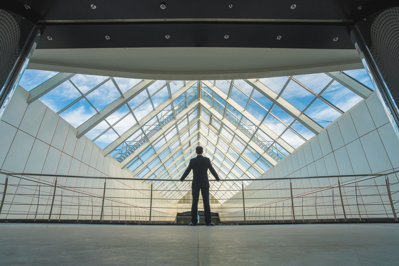 The businessman stand on the office hall