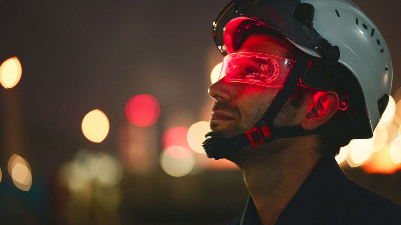 worker in a hard hat wearing futuristic protective glasses