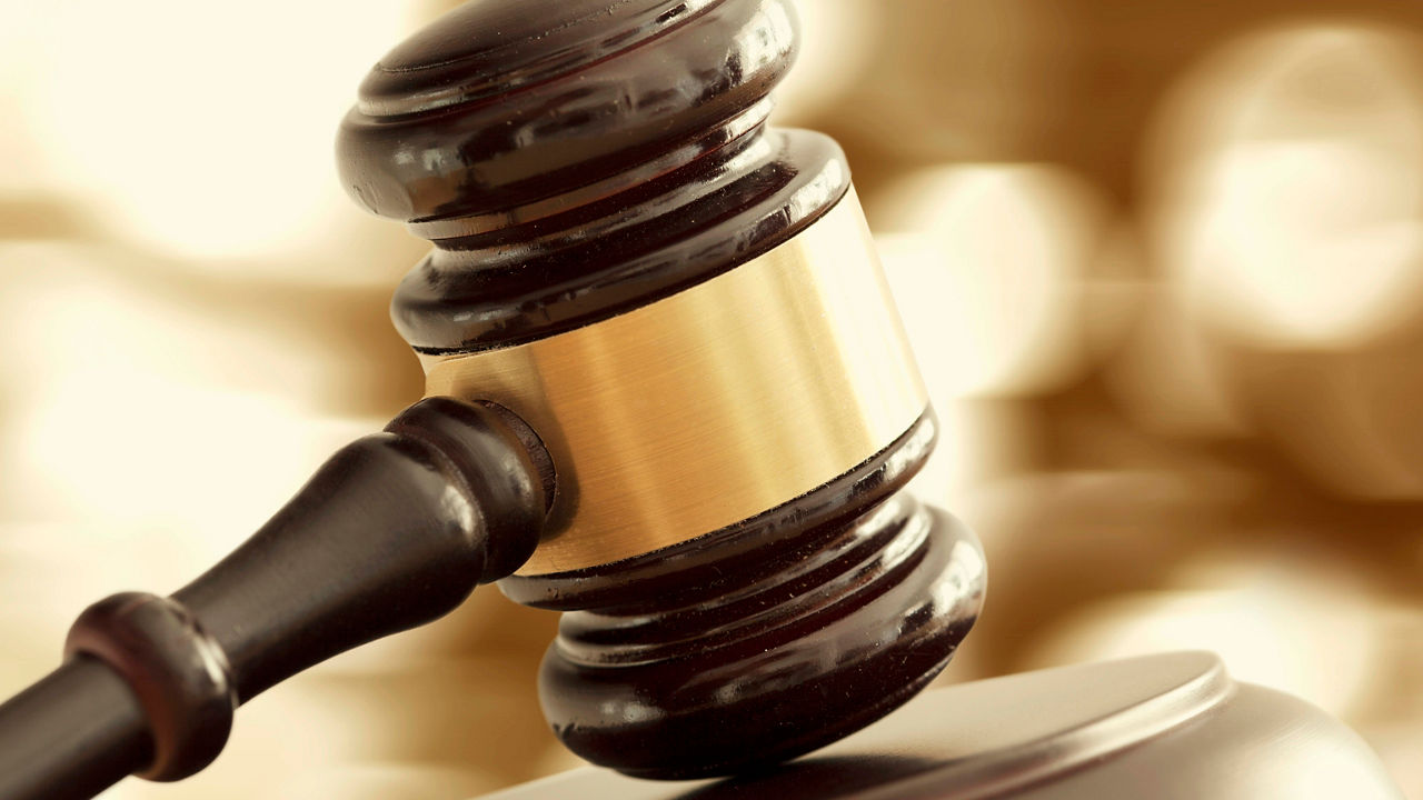 A judge's gavel sitting on top of a table.