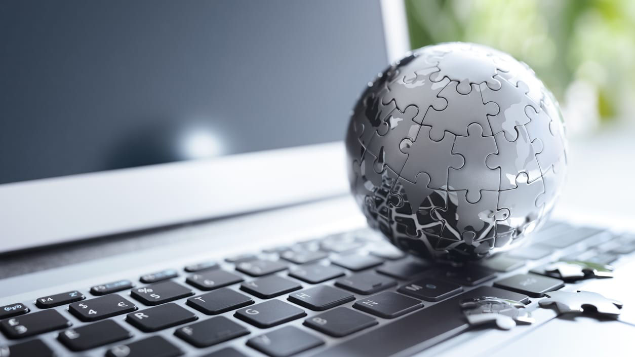 Jigsaw puzzle on the keyboard of a laptop.