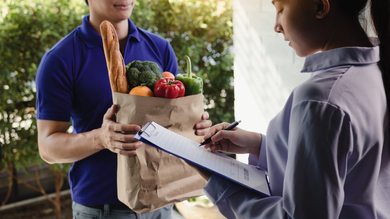 worker delivers groceries to home