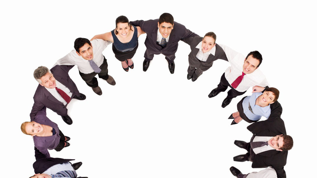 A group of business people standing in a circle.