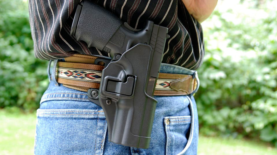 A man with a holster on his belt.