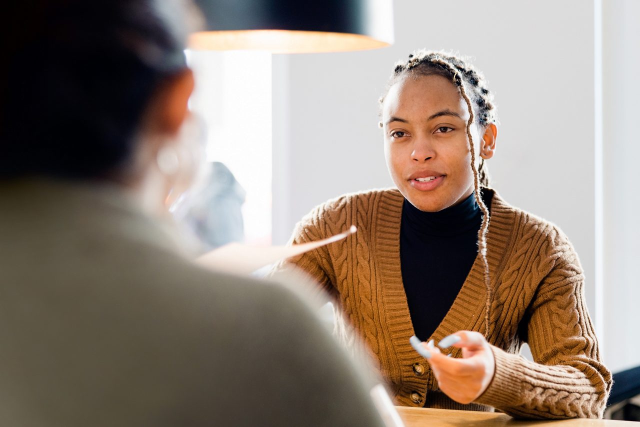 An HR professional talking with an employee