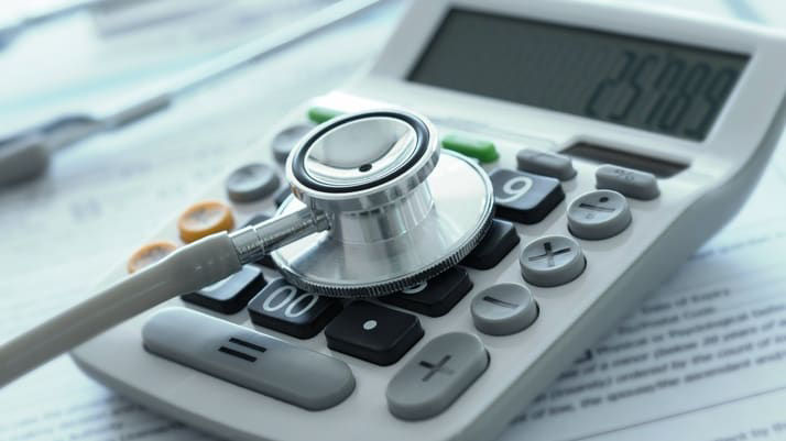 A stethoscope on top of a calculator.