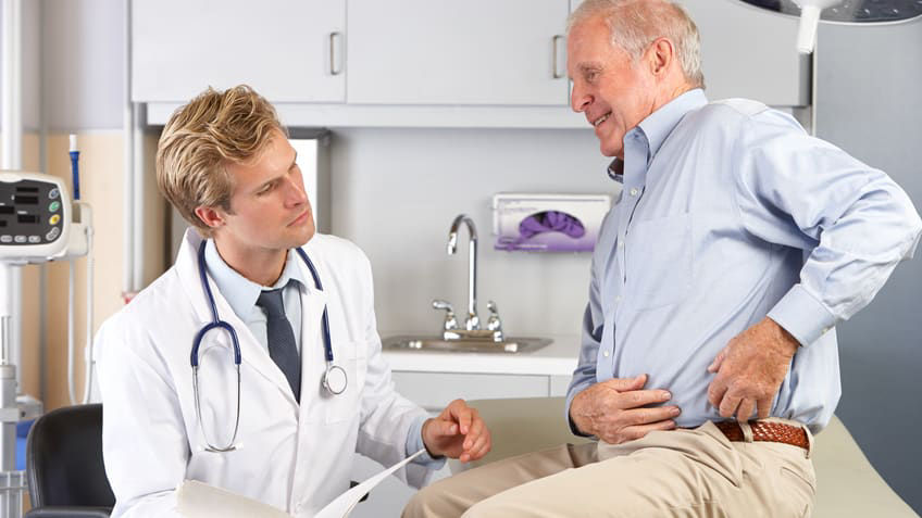 A doctor is talking to a patient in a doctor's office.