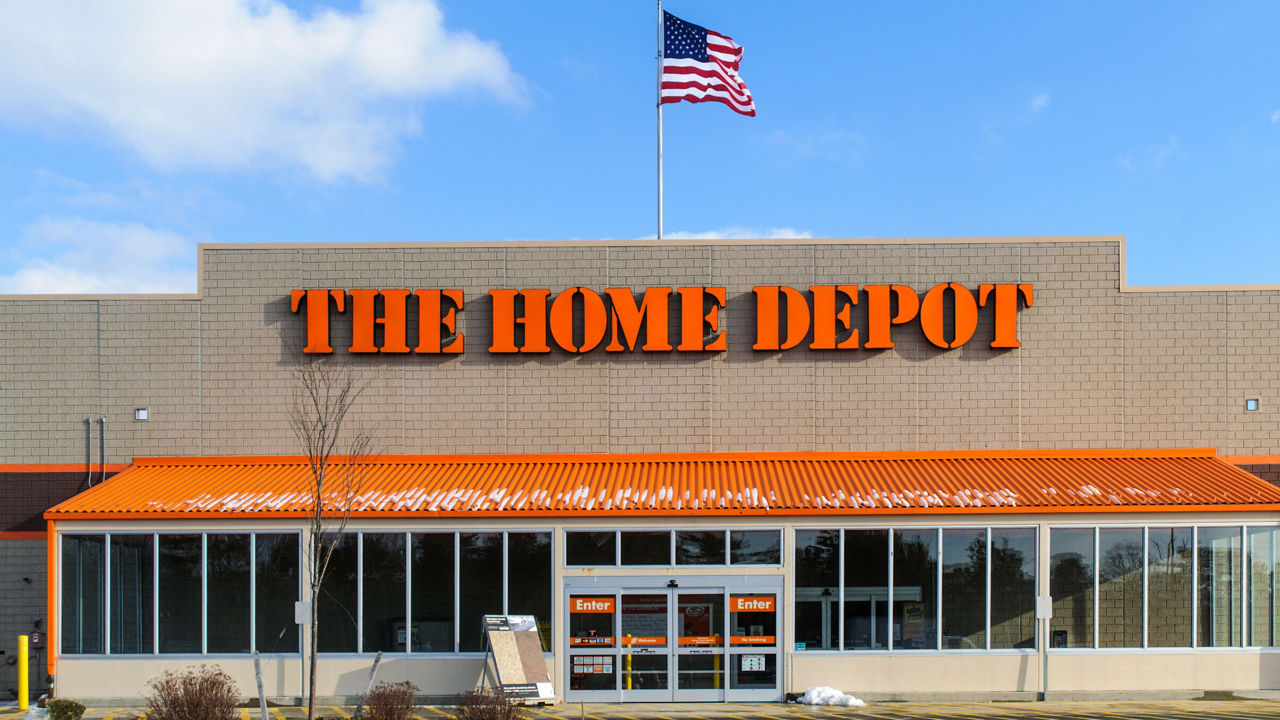 A home depot store with an american flag in front of it.
