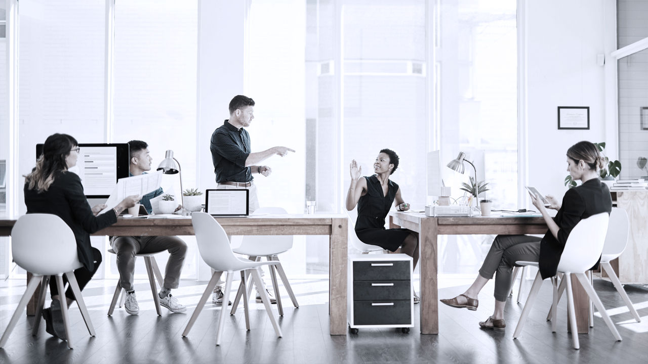 employees collaborating in an open office space