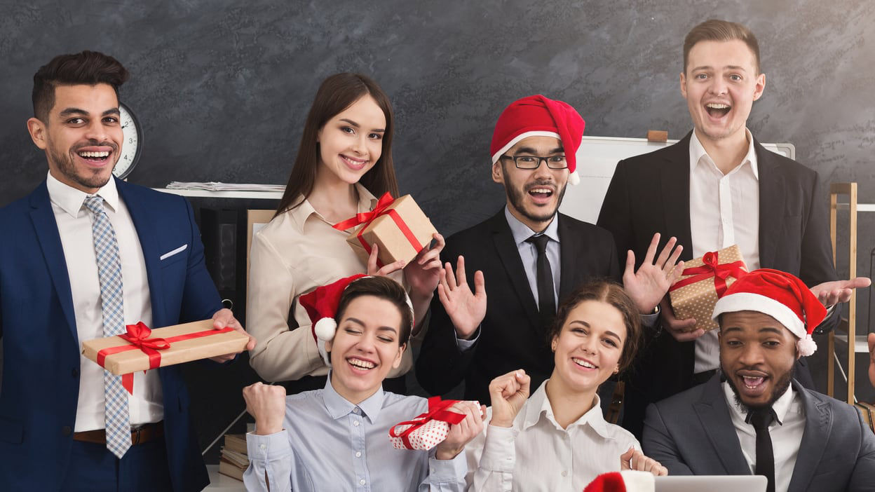 A group of people in santa hats posing for a photo.