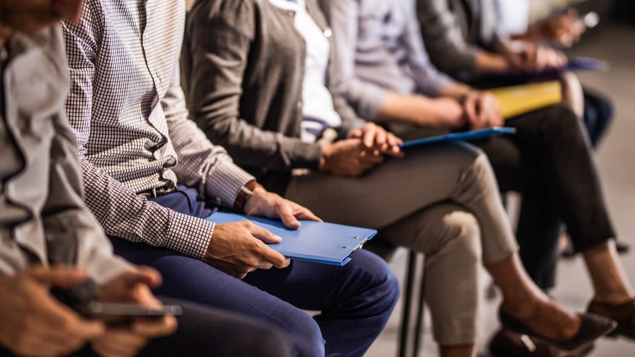 A group of business people sitting in a row.