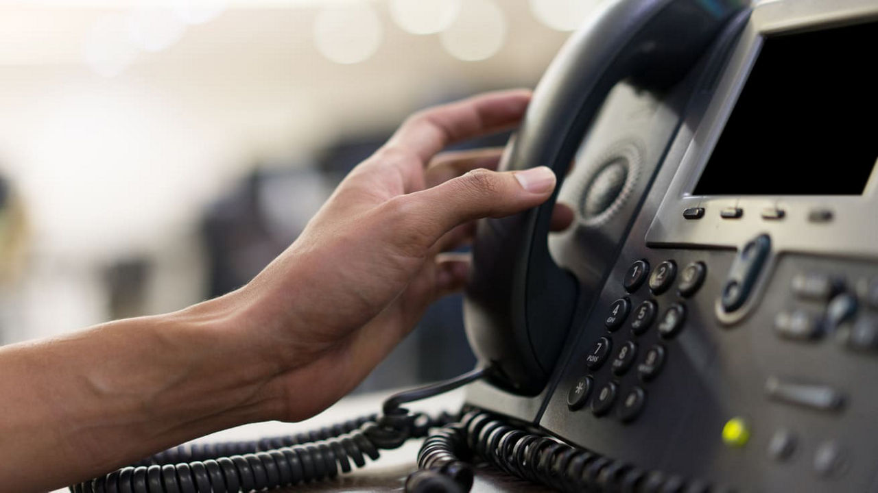A person is using a telephone to make a call.
