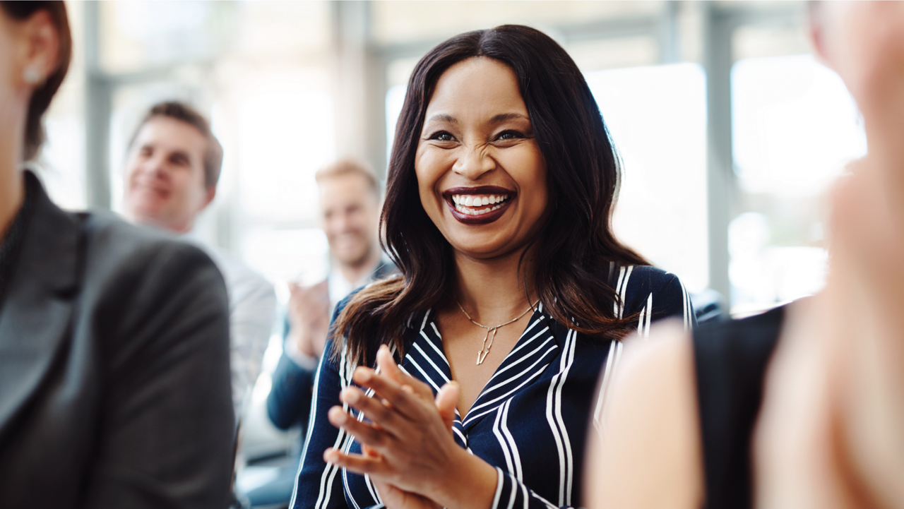Woman laughing and clapping her hands