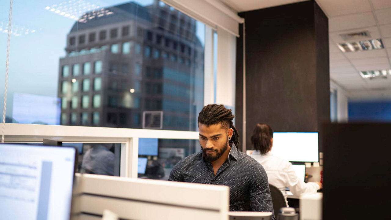 A man sitting at a desk in an office.