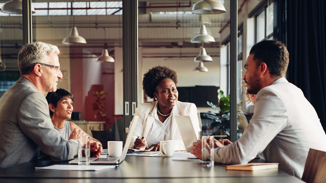 A group of business people sitting around a conference table.