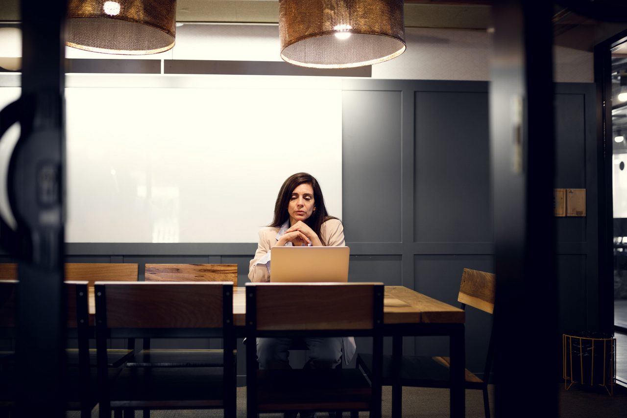 A woman working late at night in the office.