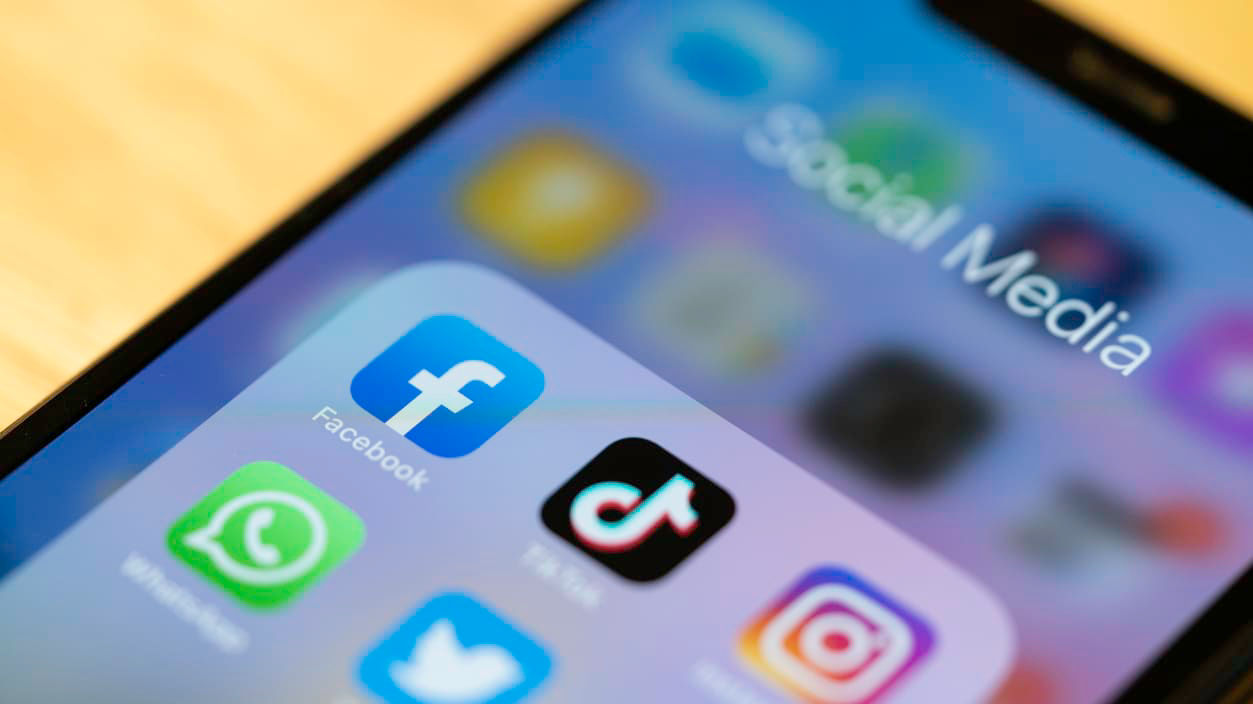 A smartphone with social media icons displayed on it.