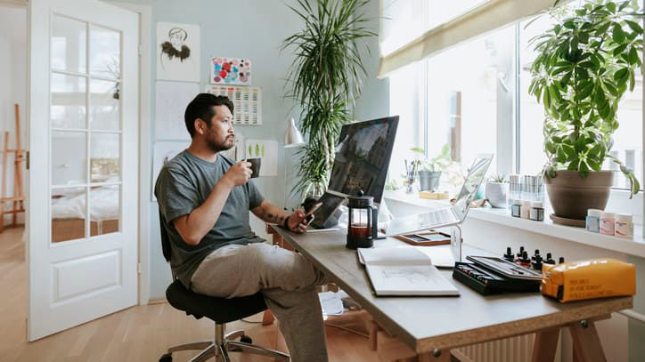 A man working at his desk in his home office.