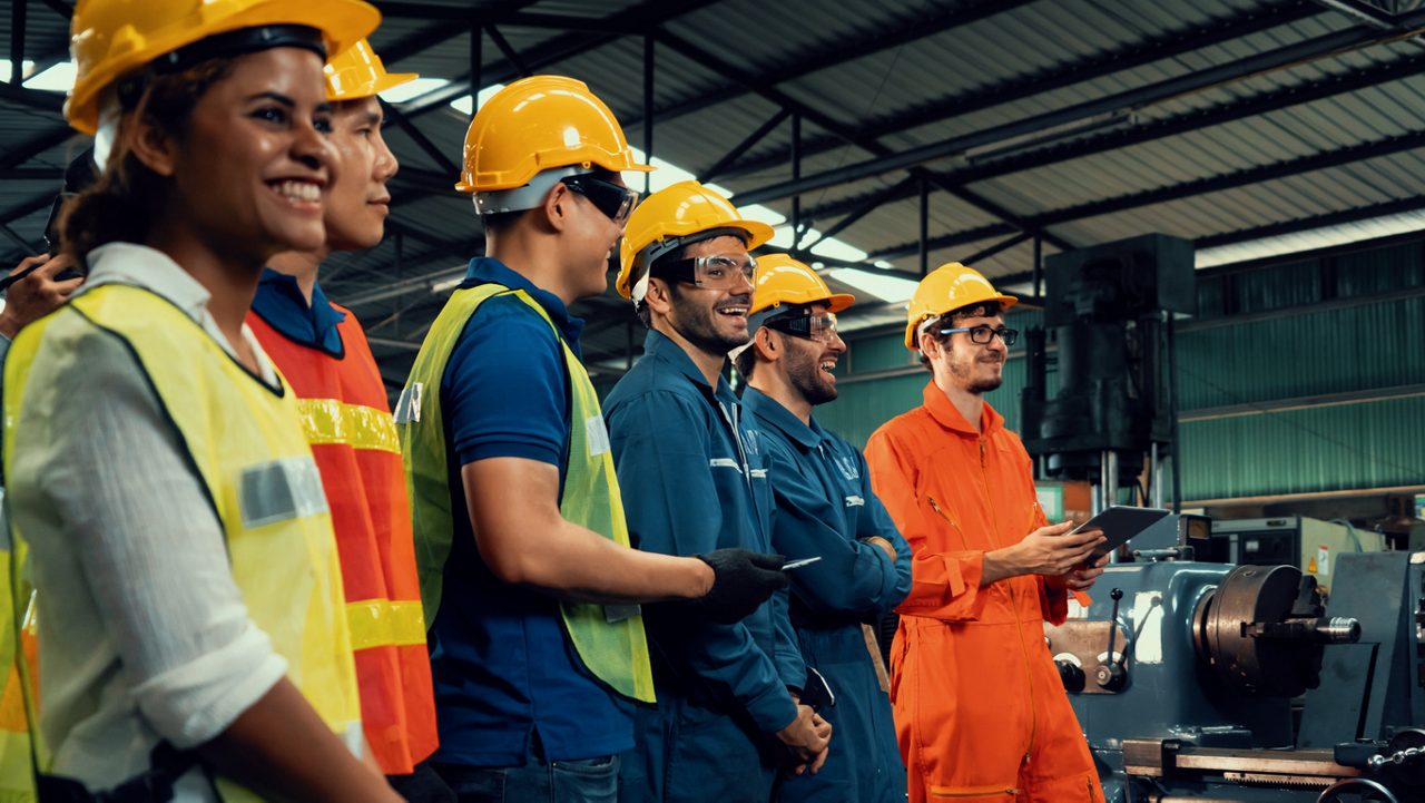 Skillful worker attending brief meeting in the factory . Industrial people and manufacturing labor concept .