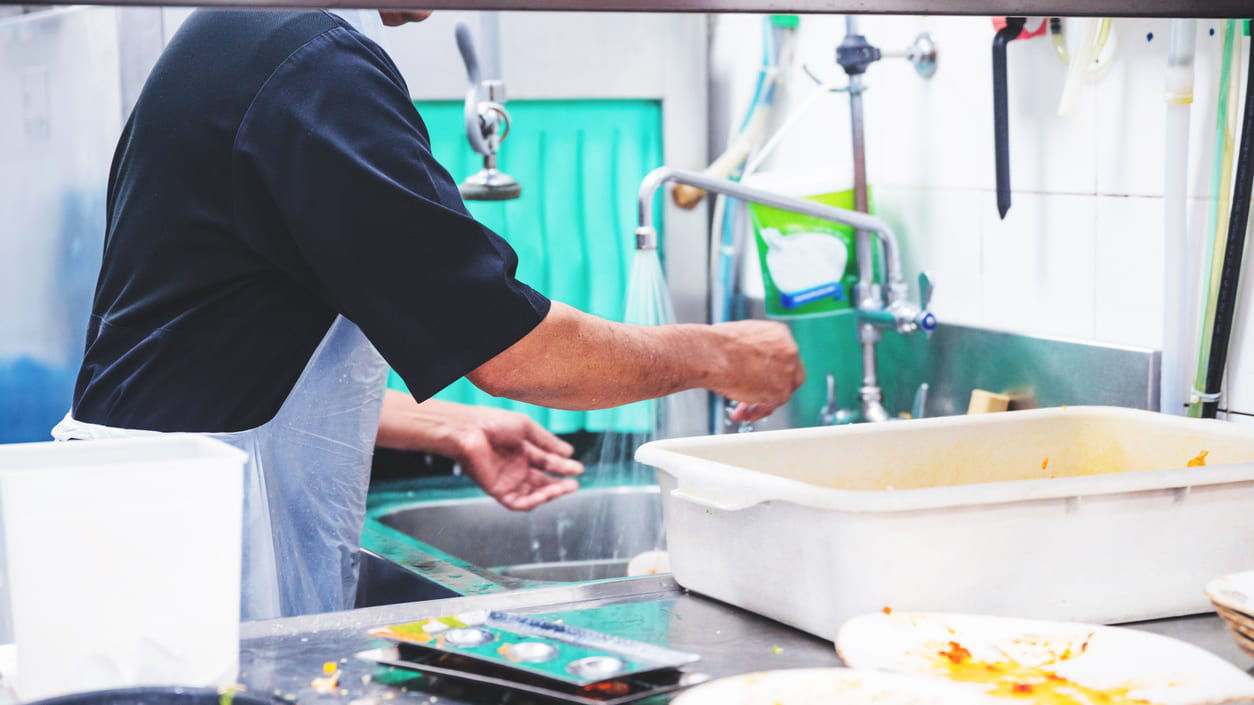 A chef is preparing food in a kitchen.