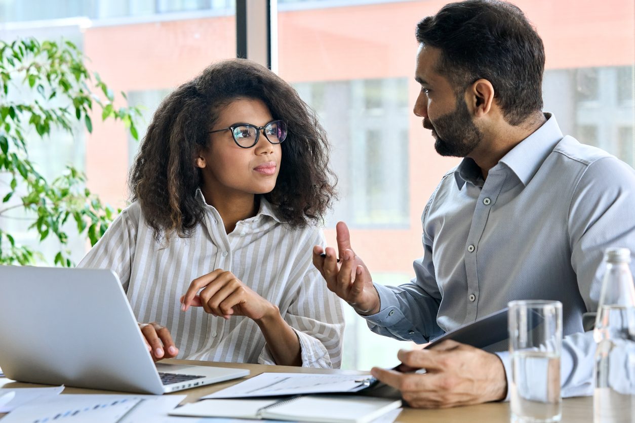 man talking to woman of color