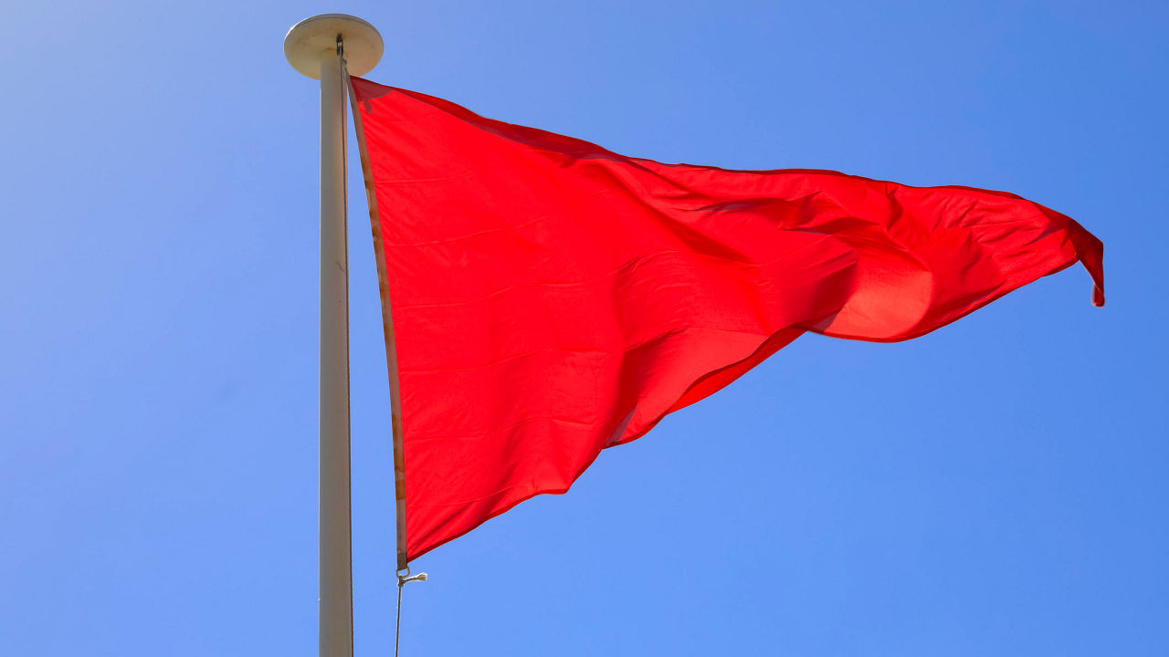 A red flag flying in the wind.